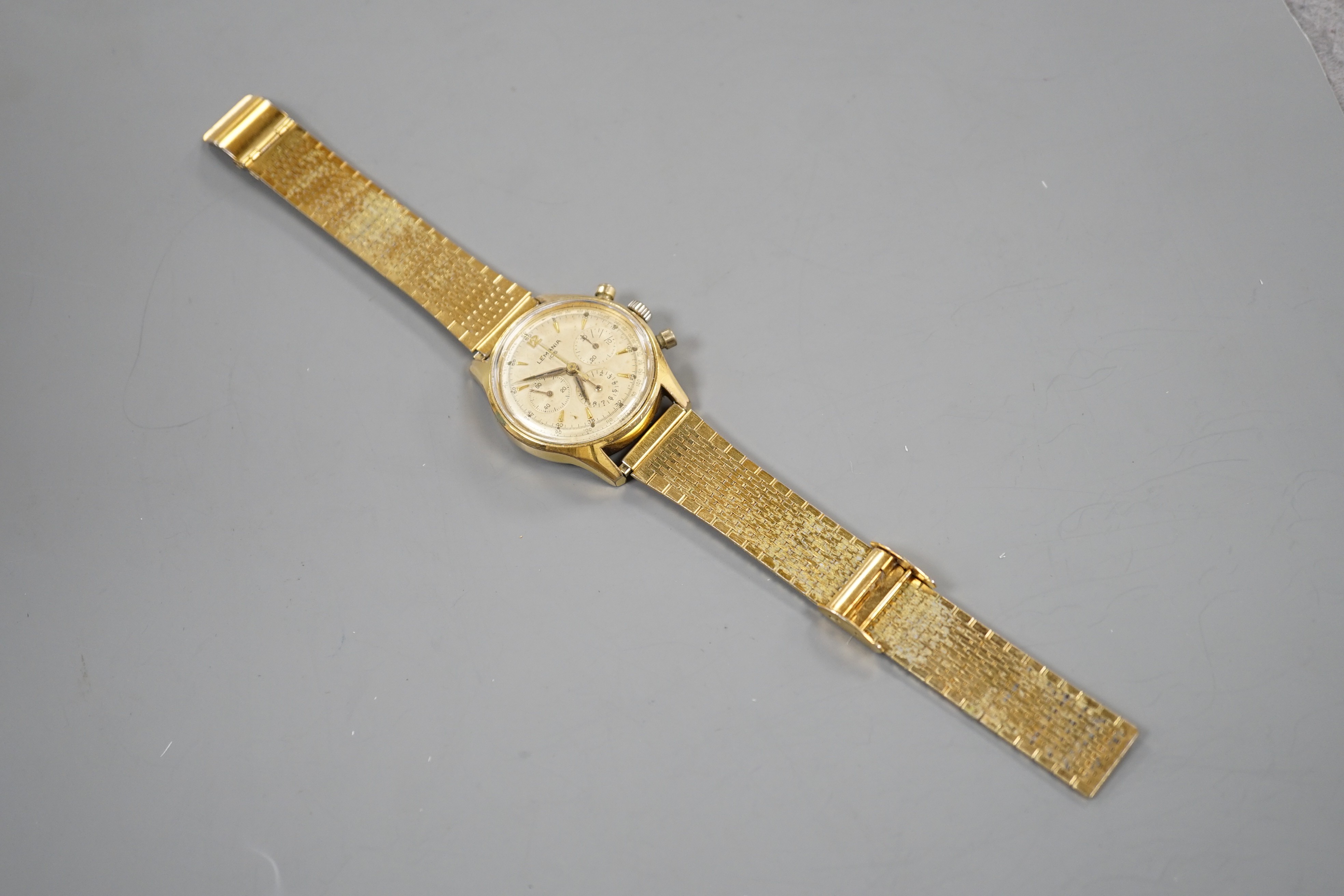 A gentleman's mid 20th century Lemania 105 steel and gold plated chronograph wrist watch, on associated steel and gold plated bracelet.